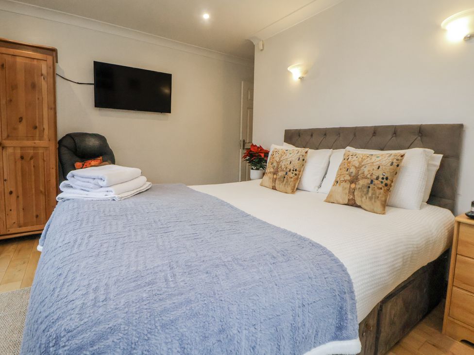 A bedroom with a bed and television at Freshwinds in Market Drayton