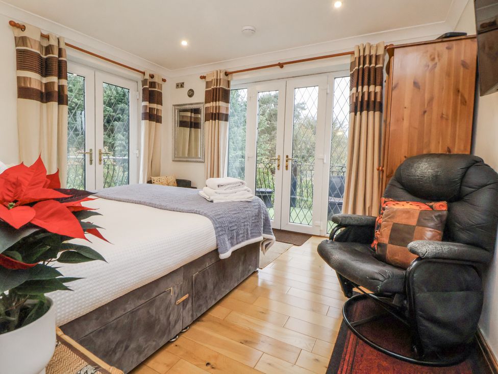 A bedroom with a bed and a chair at Freshwinds in Market Drayton