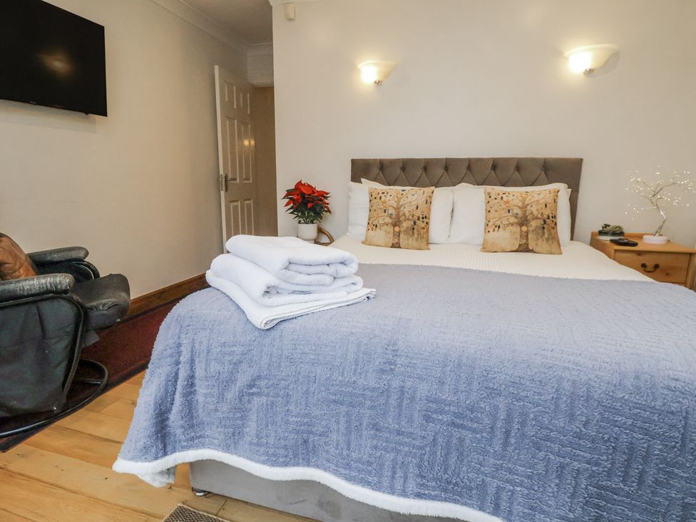 A bedroom with a bed and TV at Freshwinds in Market Drayton