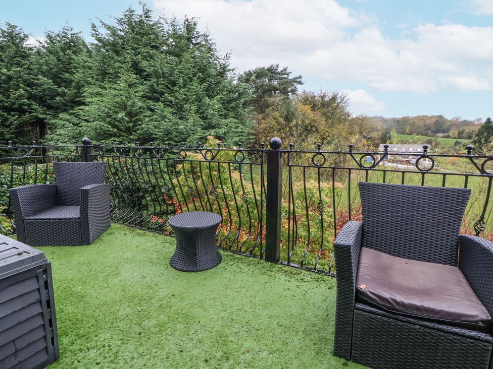 An outdoor seating area with chairs and a table at Freshwinds in Market Drayton
