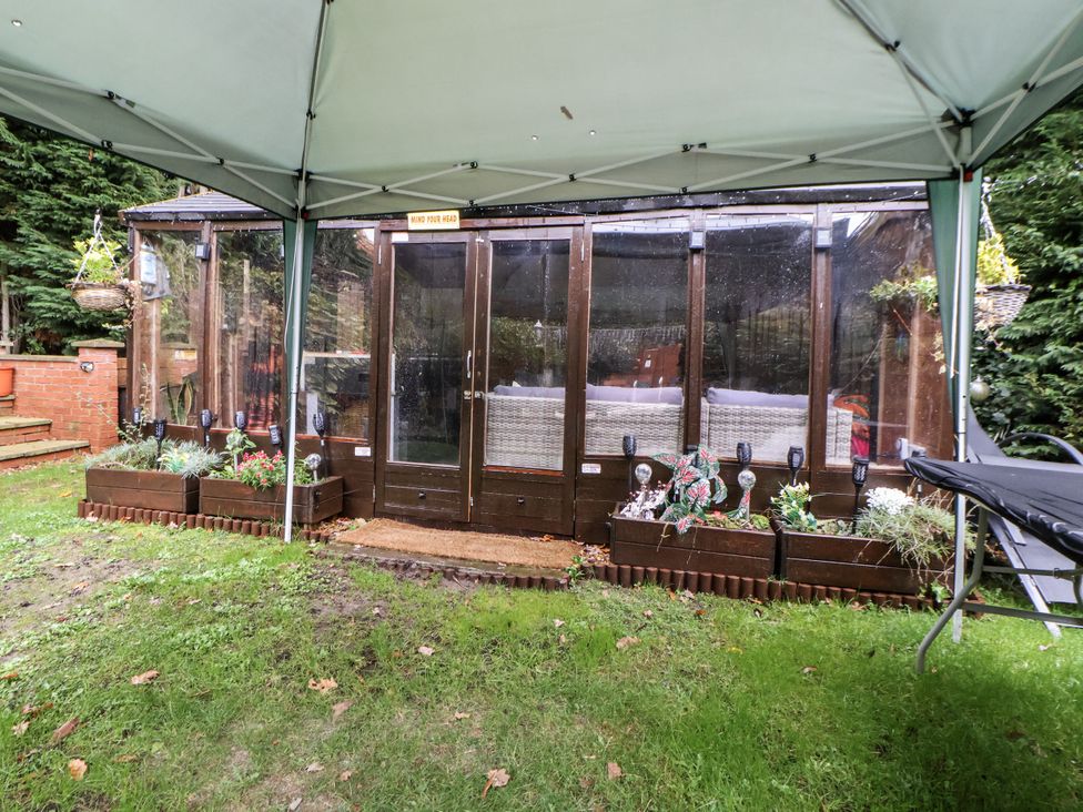 A conservatory with seating and planters at Freshwinds in Market Drayton