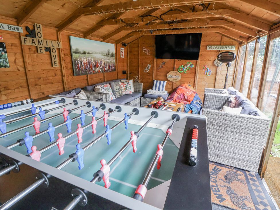 A snug with a foosball table and seating area at Freshwinds in Market Drayton