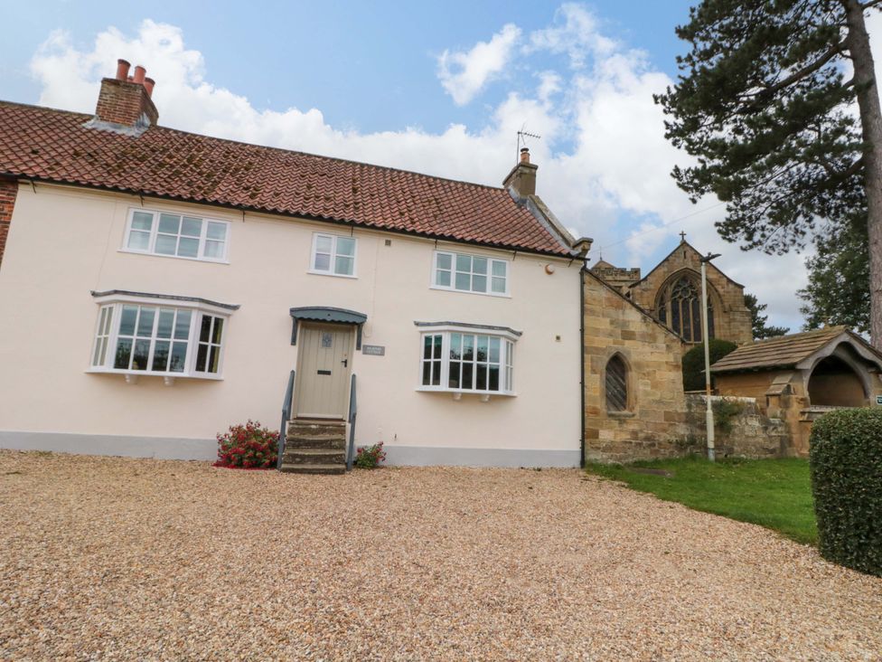 A house with a flowerbed in front at Weavers Cottage in Carlton-in-Cleveland near Stokesley