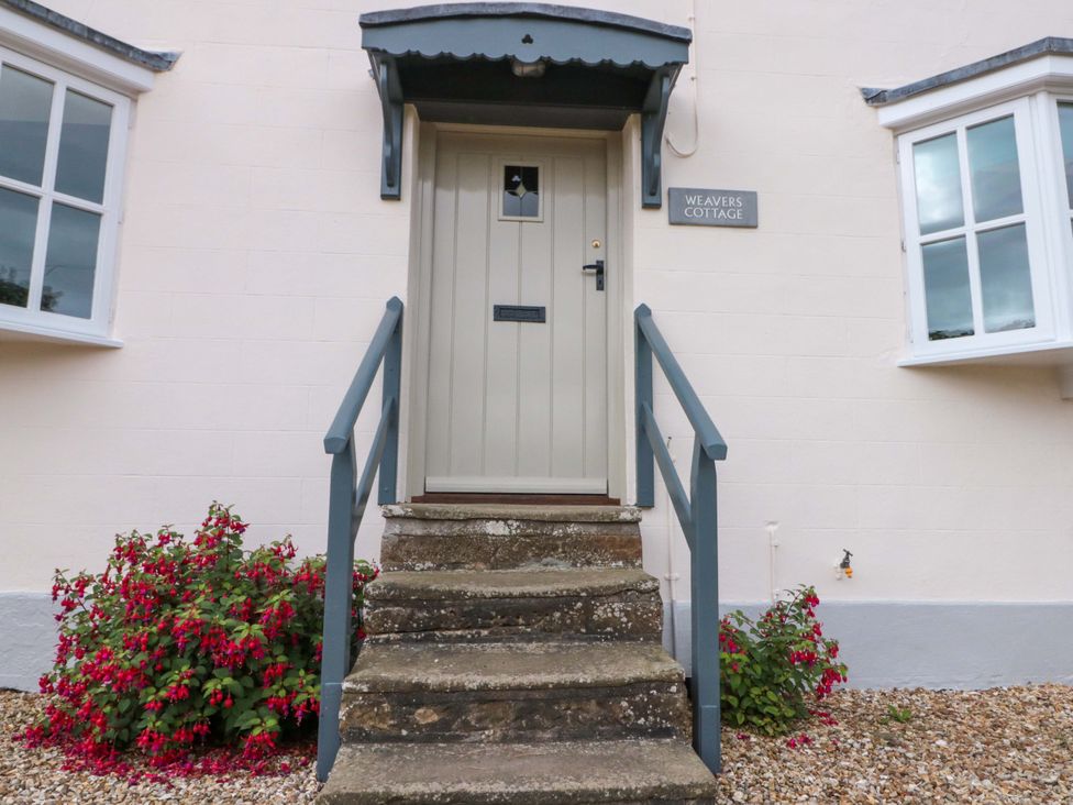 The entrance of Weavers Cottage with steps and flowers in Carlton-in-Cleveland near Stokesley