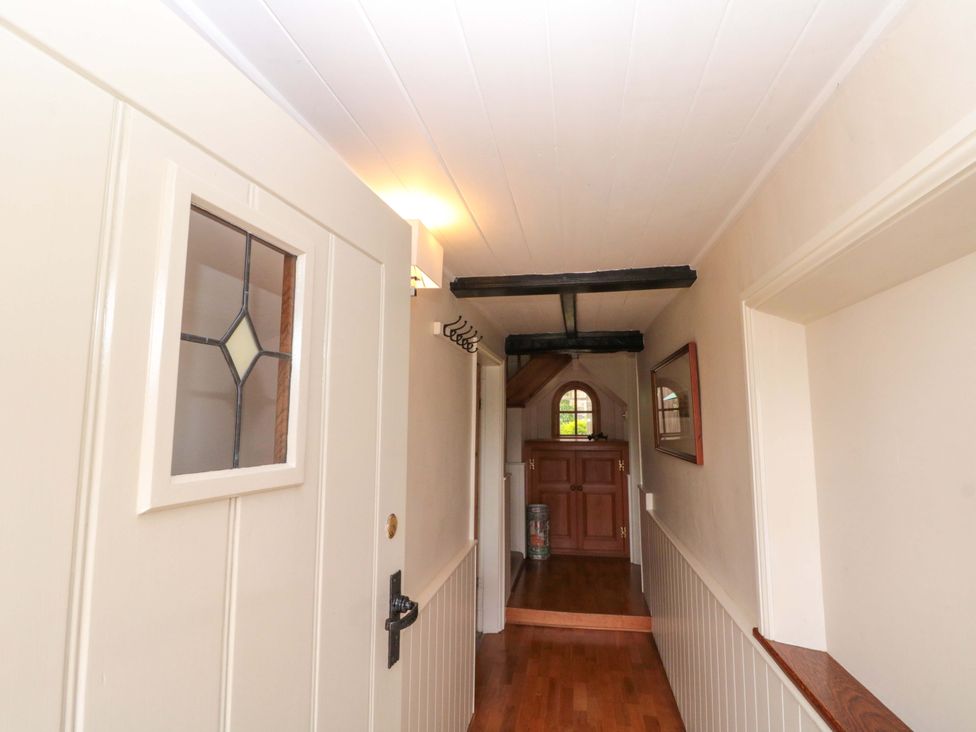 A hallway with a wooden floor and staircase at Weavers Cottage in Carlton-in-Cleveland near Stokesley