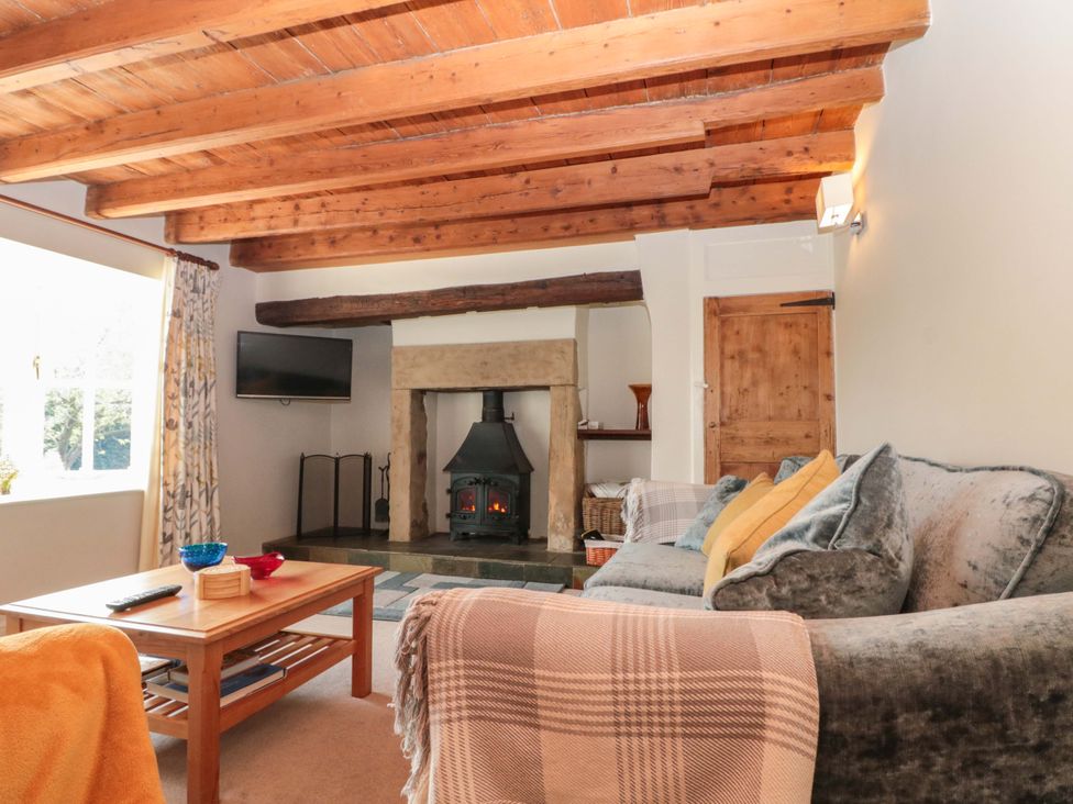 A living room with a fireplace and a sofa at Weavers Cottage in Carlton-in-Cleveland near Stokesley