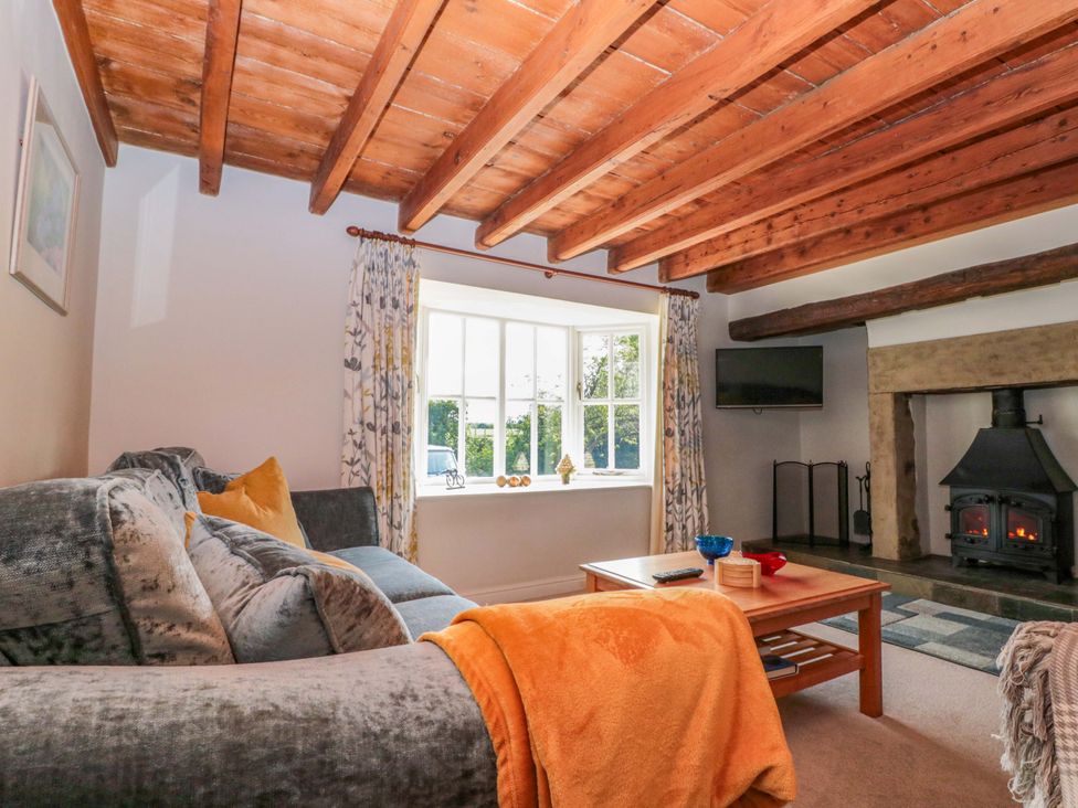 A living room with a sofa and coffee table at Weavers Cottage in Carlton-in-Cleveland near Stokesley