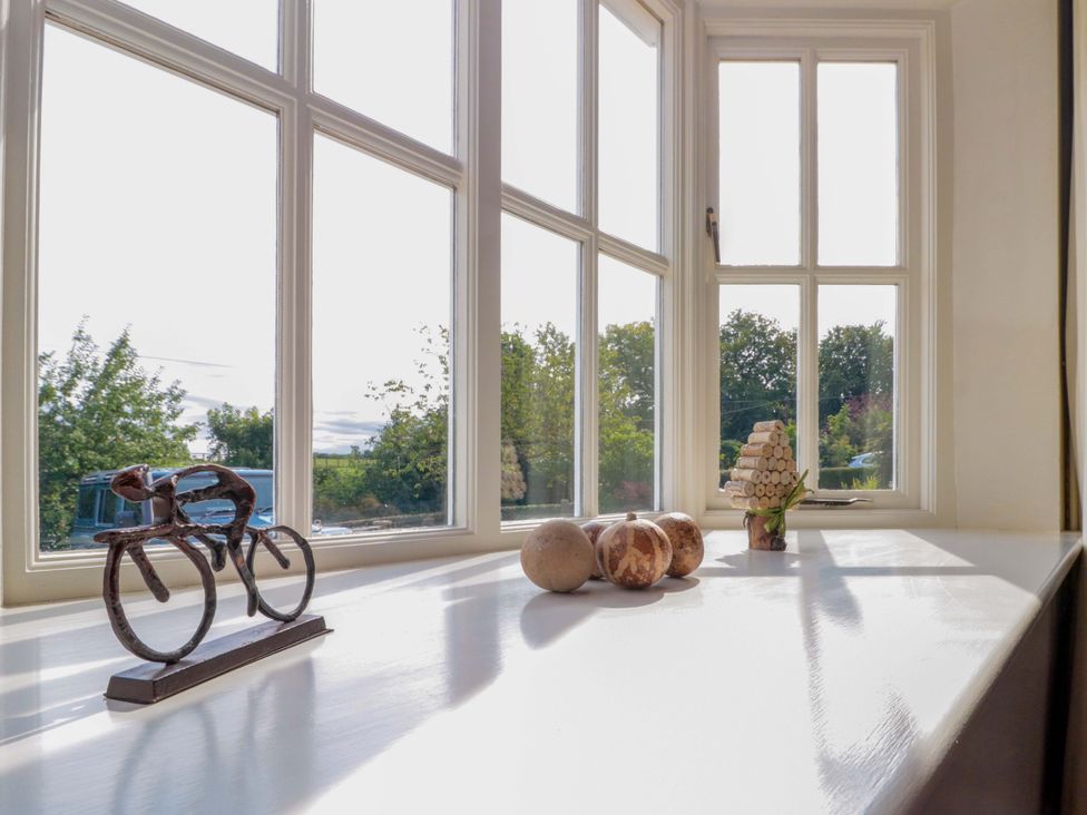A window with decorative items on a table at Weavers Cottage in Carlton-in-Cleveland near Stokesley