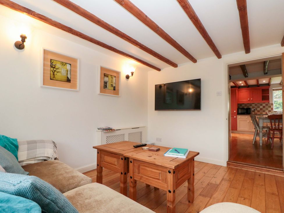 A living room with a sofa and TV at Weavers Cottage in Carlton-in-Cleveland near Stokesley
