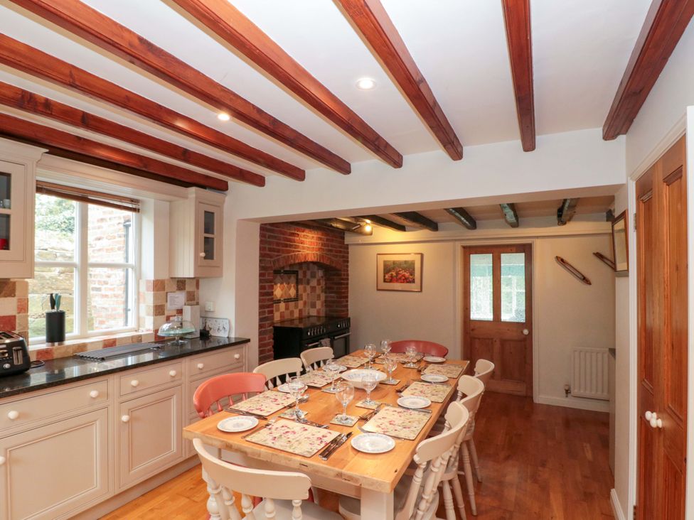 A kitchen with a dining table and chairs at Weavers Cottage in Carlton-in-Cleveland near Stokesley
