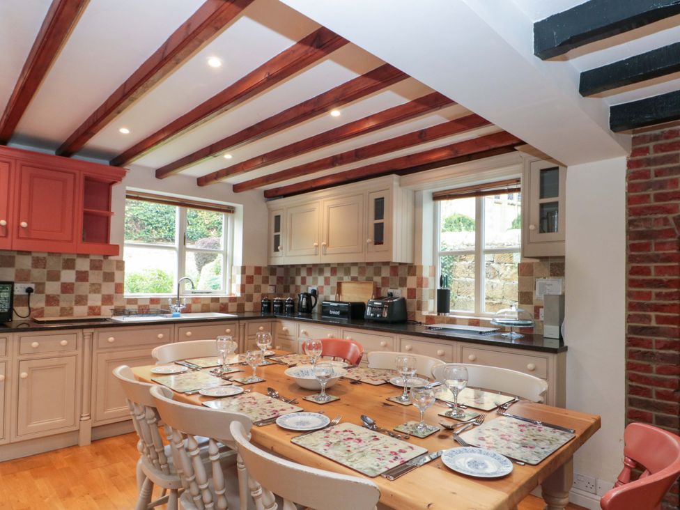 A kitchen with a dining table and chairs at Weavers Cottage Carlton-in-Cleveland near Stokesley