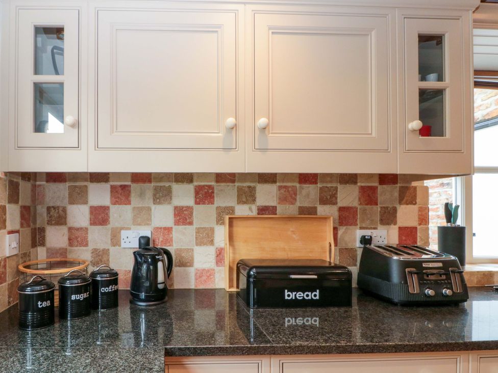 A kitchen countertop with a kettle, toaster, and canisters at Weavers Cottage Carlton-in-Cleveland near Stokesley