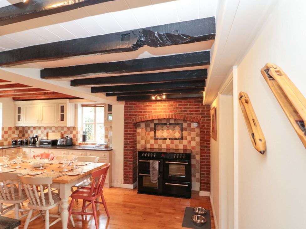 A kitchen with a dining table and chairs at Weavers Cottage in Carlton-in-Cleveland near Stokesley