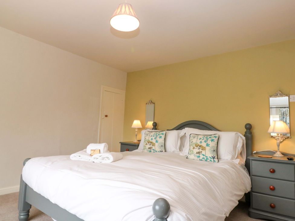 A bedroom with a double bed and bedside tables at Weavers Cottage Carlton-in-Cleveland near Stokesley