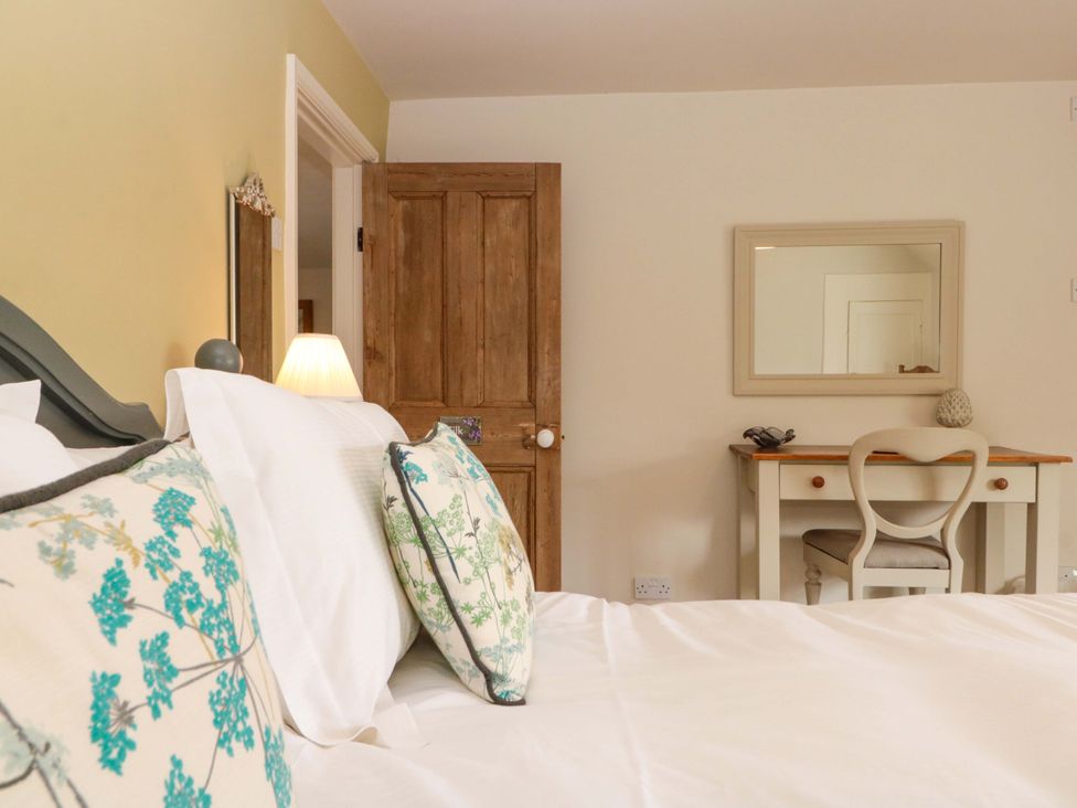 A bedroom with a bed and a desk at Weavers Cottage in Carlton-in-Cleveland near Stokesley