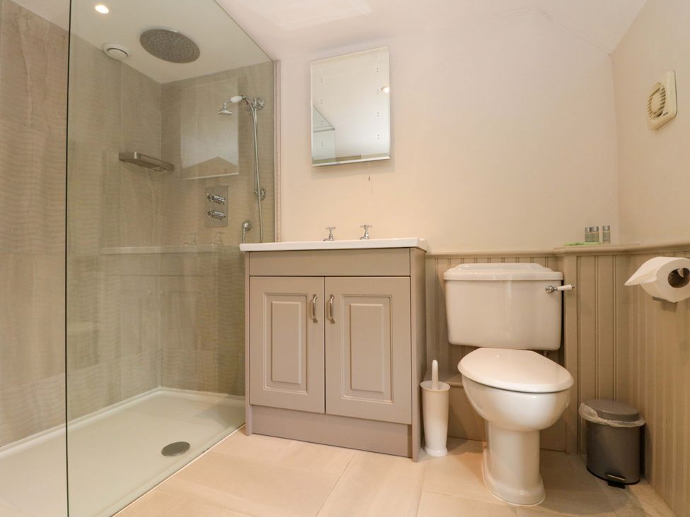 A bathroom with a shower, sink, and toilet at Weavers Cottage Carlton-in-Cleveland near Stokesley