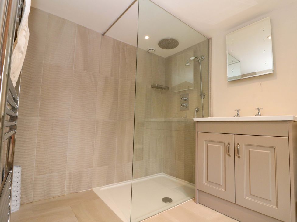 A bathroom with a shower and sink at Weavers Cottage Carlton-in-Cleveland near Stokesley
