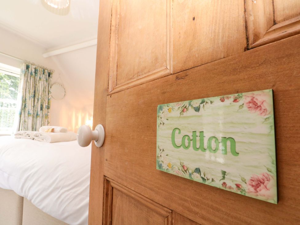 A door with a sign labeled Cotton leading to a bedroom at Weavers Cottage in Carlton-in-Cleveland near Stokesley
