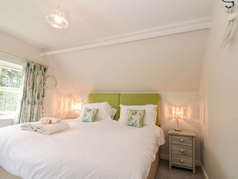 A bedroom with a double bed and bedside table at Weavers Cottage Carlton-in-Cleveland near Stokesley