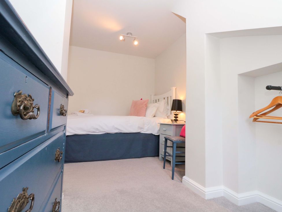 A bedroom with a bed and nightstand at Weavers Cottage Carlton-in-Cleveland near Stokesley
