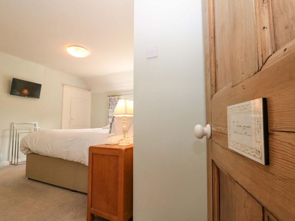 A bedroom with a bed and a television at Weavers Cottage in Carlton-in-Cleveland near Stokesley