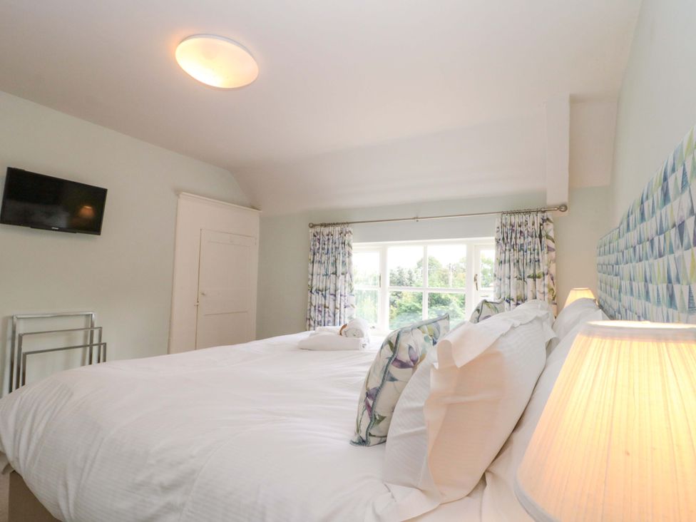 A bedroom with a bed and television at Weavers Cottage Carlton-in-Cleveland near Stokesley