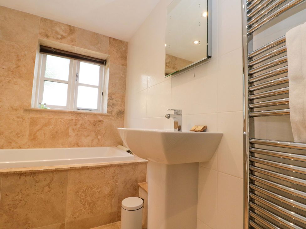 A bathroom with a sink and bathtub at Weavers Cottage in Carlton-in-Cleveland near Stokesley