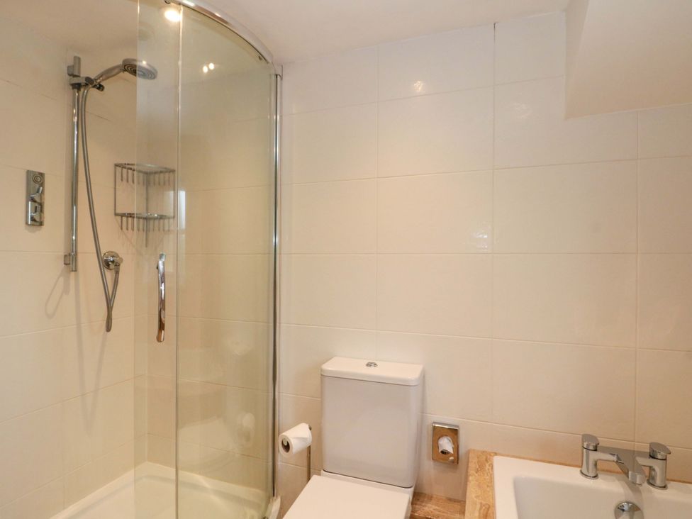 A bathroom featuring a shower, toilet, and sink at Weavers Cottage in Carlton-in-Cleveland near Stokesley