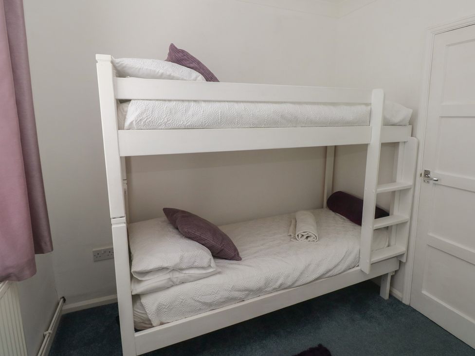 A bedroom with a bunk bed at Cwtch Ar Y Mor Burry Port