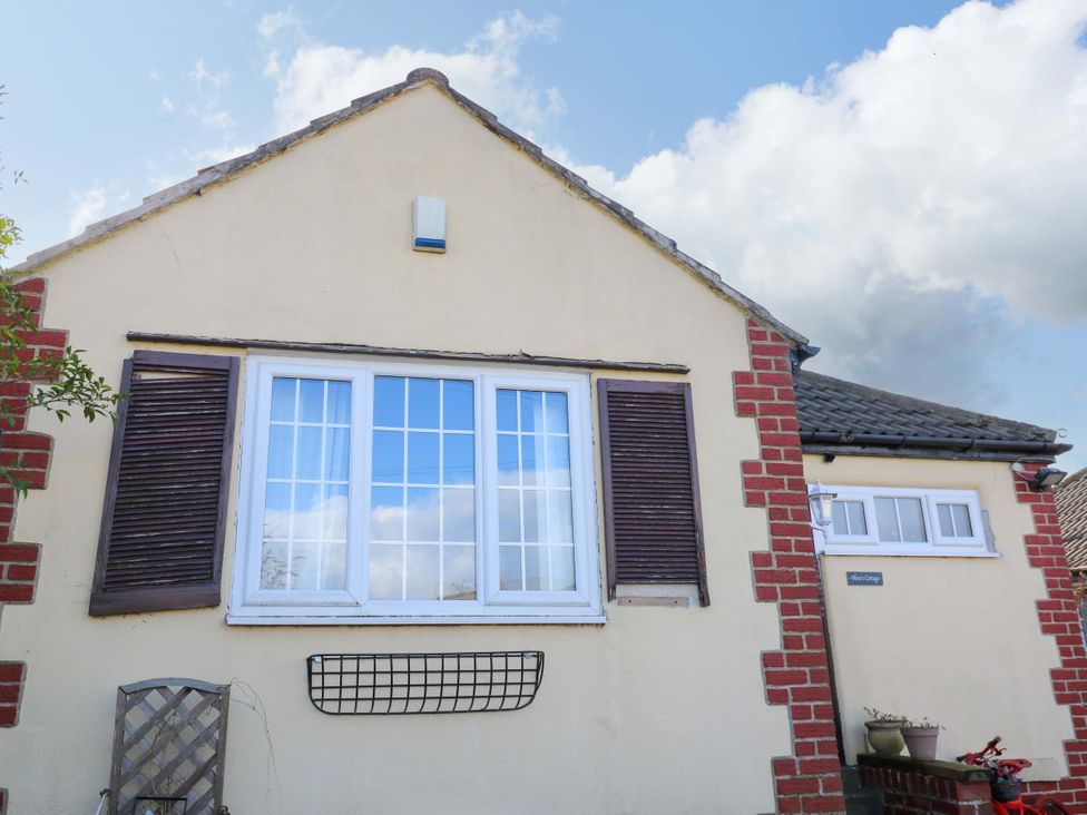 A house exterior with a window and door at Hira's Cottage