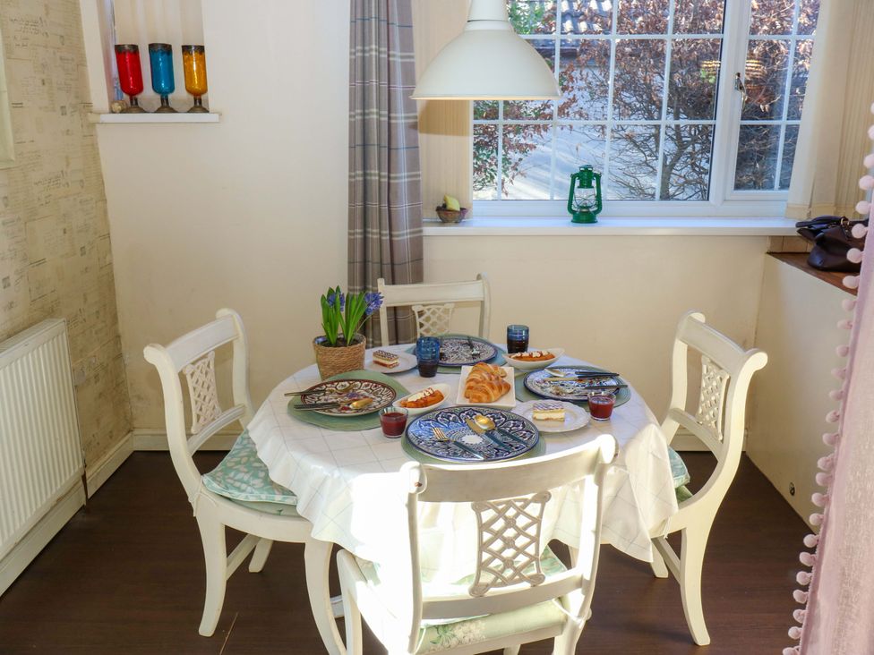 A dining room with a table set for breakfast at Hira's Cottage 
