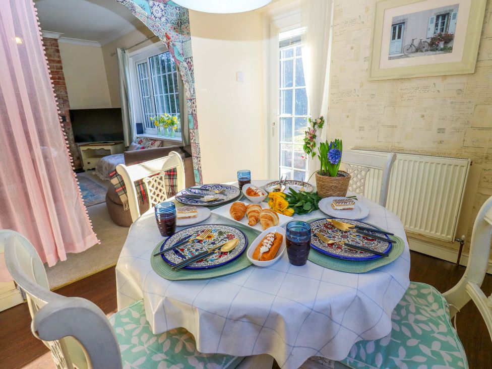 A dining room with a table set for breakfast at Hira's Cottage 