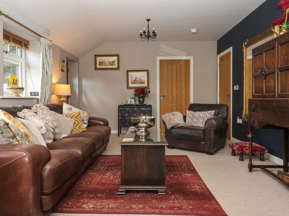 A living room with sofa and armchair at 1 Church Barns in Pocklington