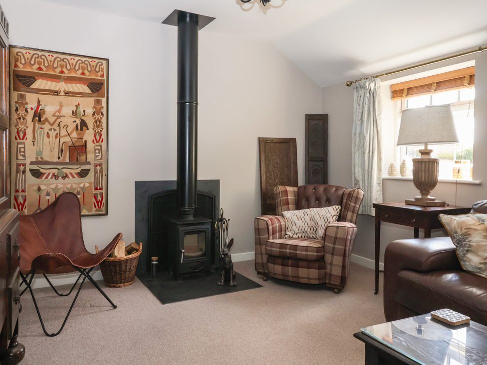 A living room with a wood-burning stove and decorative wall art at 1 Church Barns Pocklington