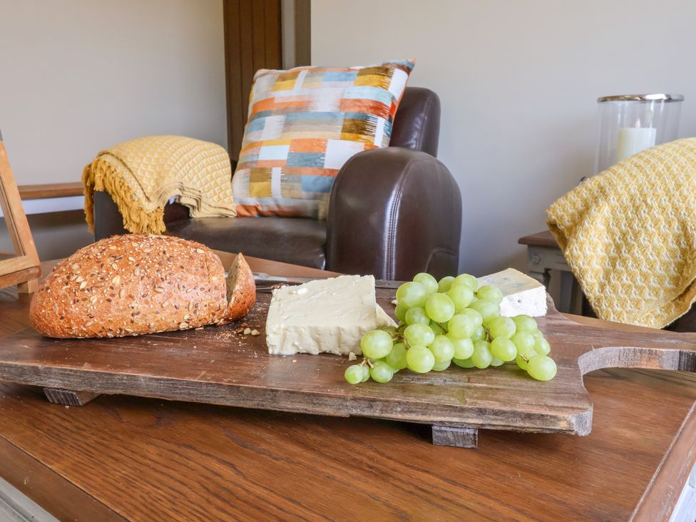 A coffee table with bread, cheese, and grapes at 1 Church Barns, Pocklington