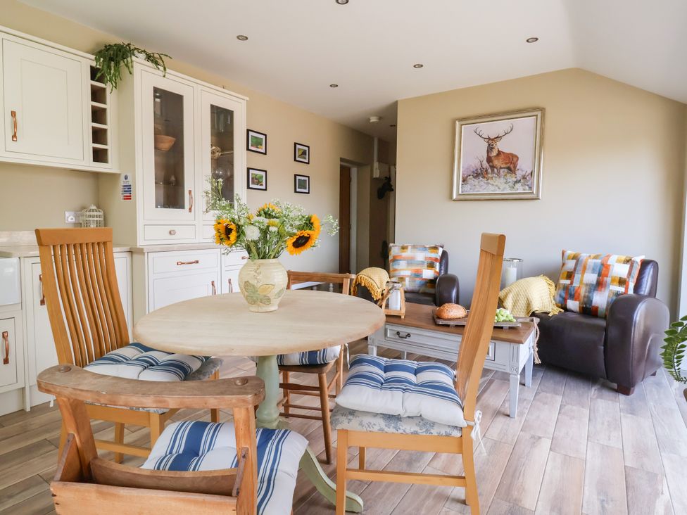 A dining room with a table and chairs at 1 Church Barns Pocklington