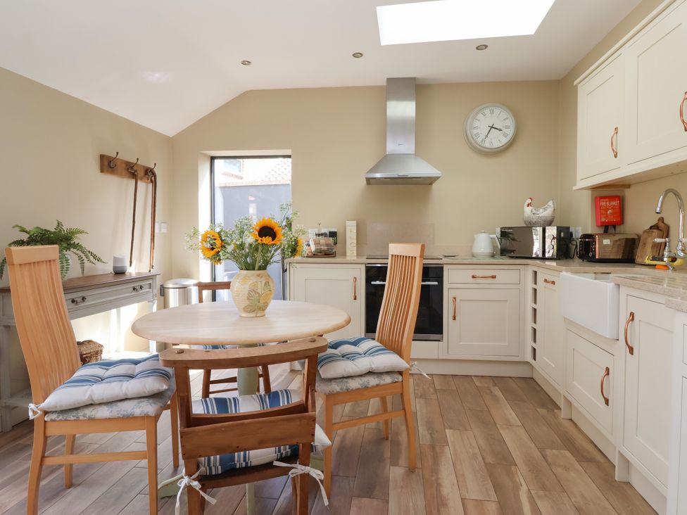 A kitchen with a table and chairs at 1 Church Barns Pocklington