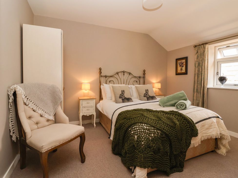 A bedroom with a bed and chair at 1 Church Barns Pocklington