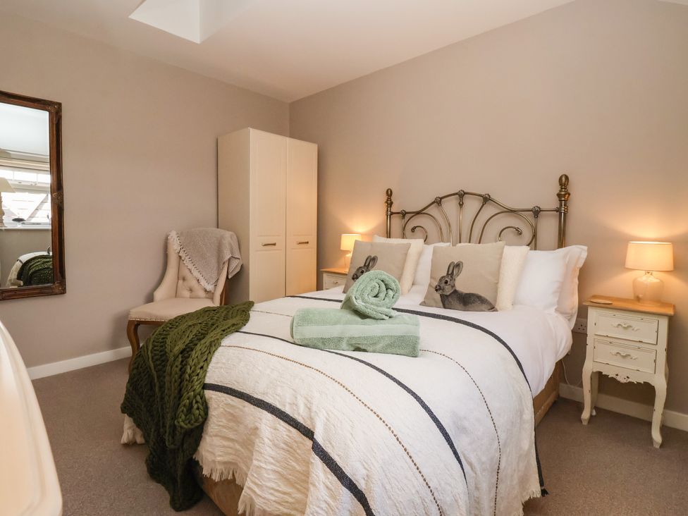 A bedroom with a bed, wardrobe, and chair at 1 Church Barns Pocklington