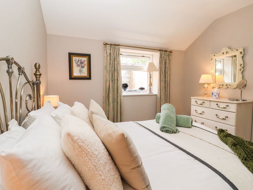 A bedroom with a bed and window at 1 Church Barns in Pocklington