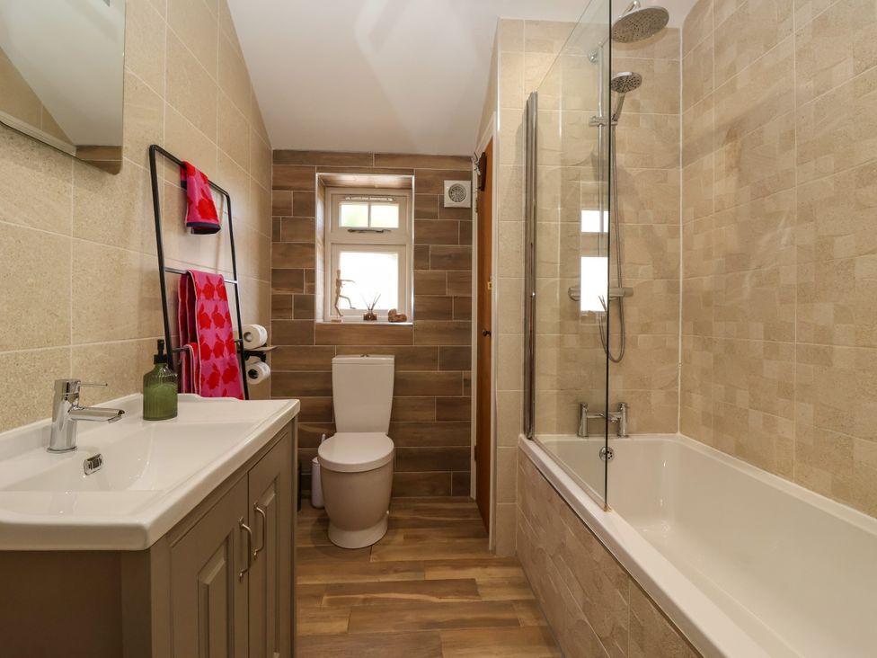 A bathroom with sink, toilet, and bath tub at 1 Church Barns Pocklington