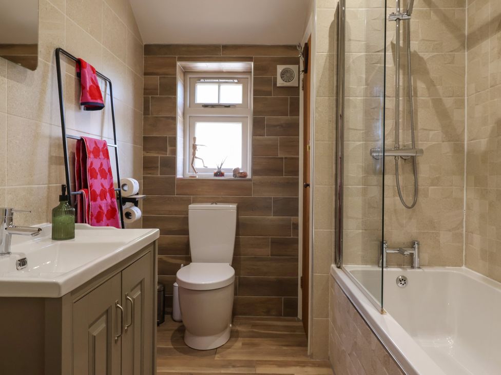 A bathroom with a toilet, bathtub, sink, and shower at 1 Church Barns Pocklington