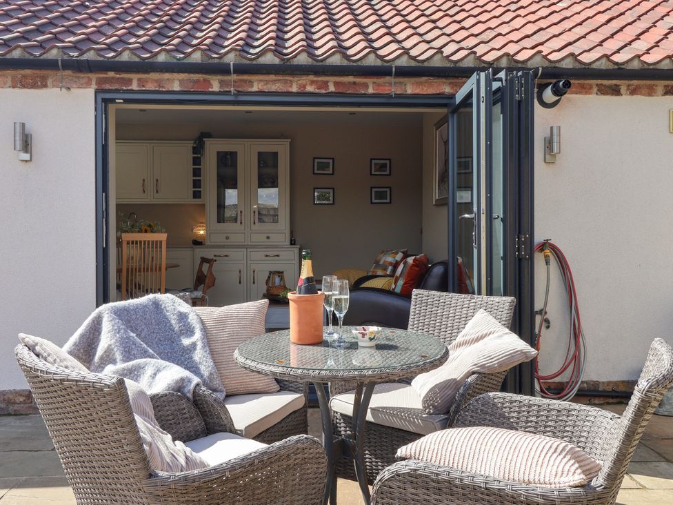 An outdoor seating area with chairs and a table at 1 Church Barns Pocklington