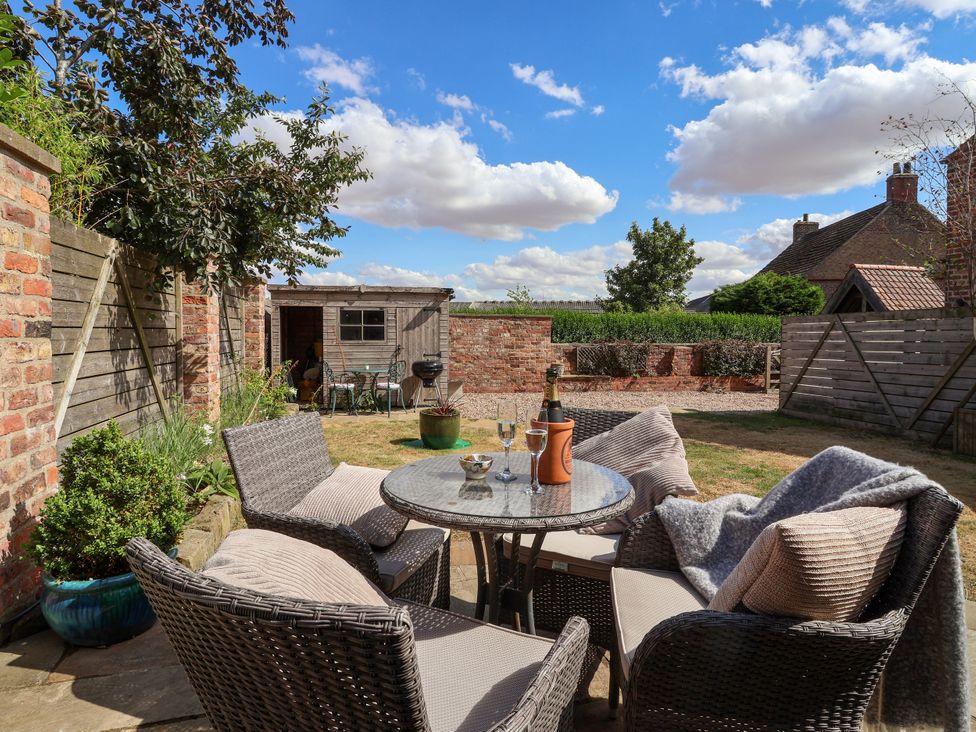 An outdoor garden featuring a table and chairs at 1 Church Barns Pocklington