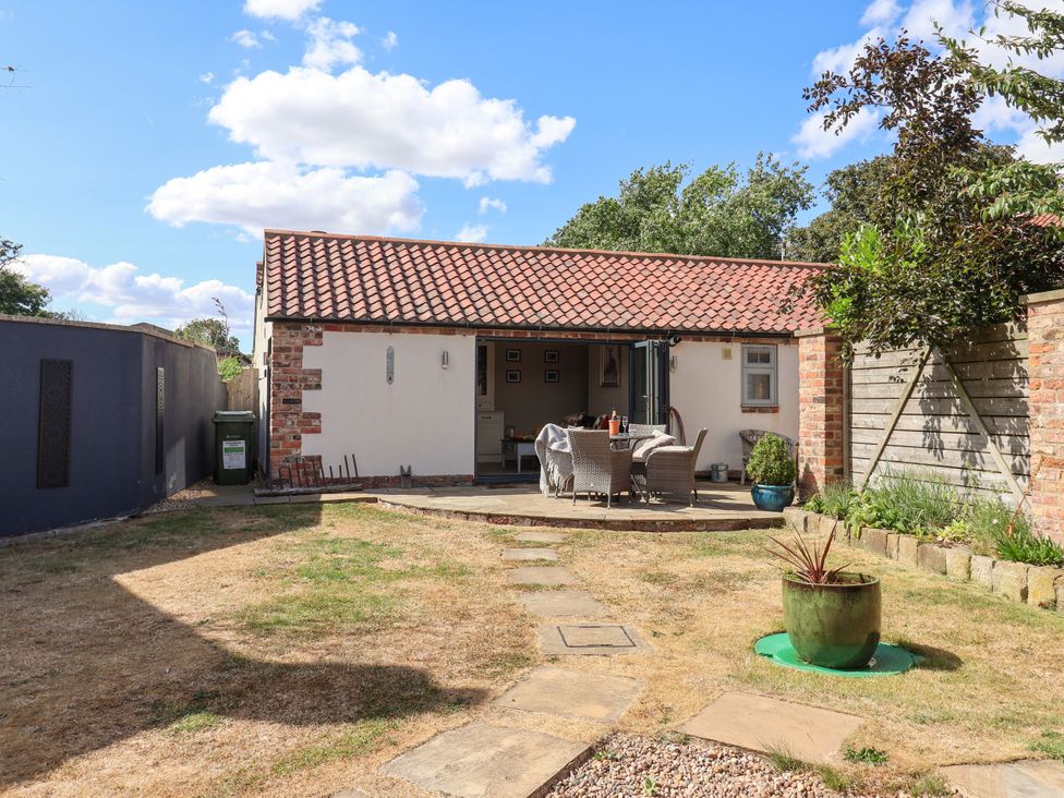A garden with a patio and seating area at 1 Church Barns Pocklington