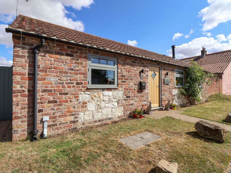 A brick building with a front door and window at 1 Church Barns in Pocklington