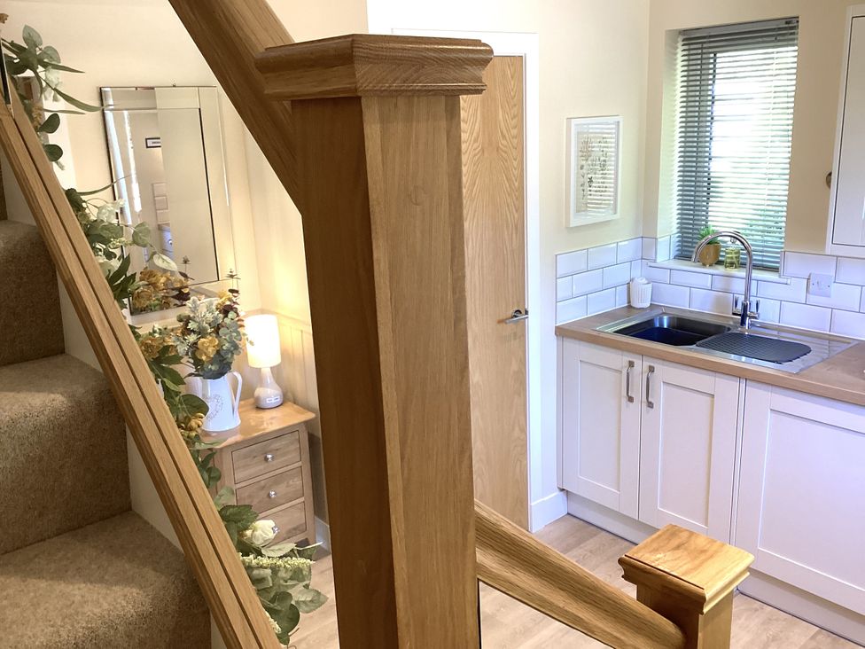 A kitchen with a sink and storage at Larchwood Lodge in Ellon