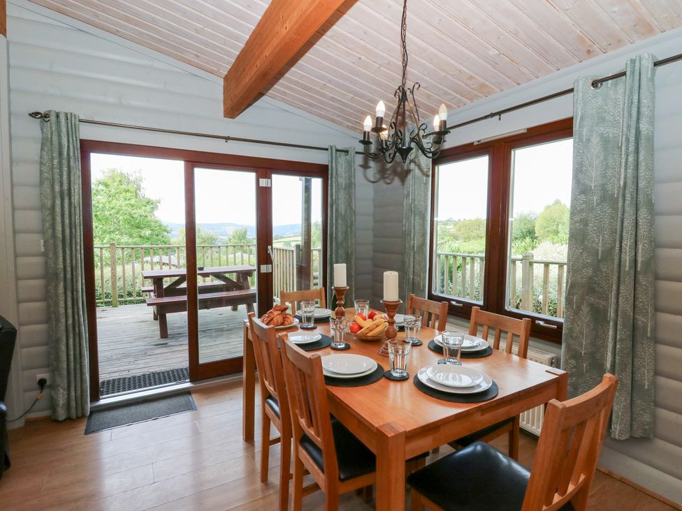 A dining room with a table and chairs at Sunny View in Rhayader