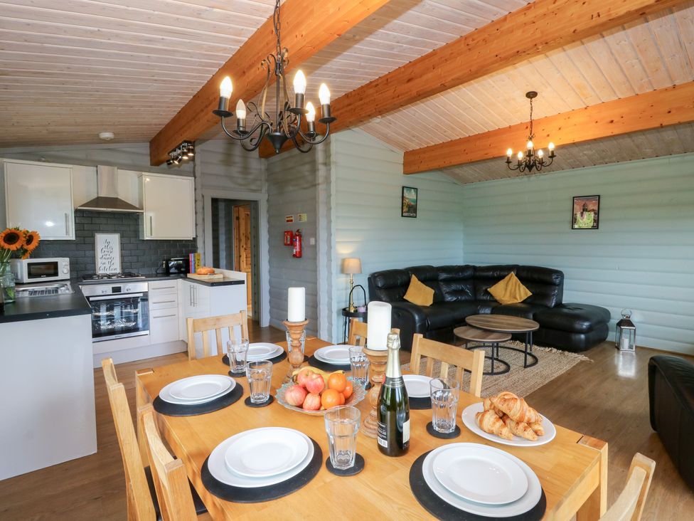 A dining room with a table set for meals at Sunny View in Rhayader
