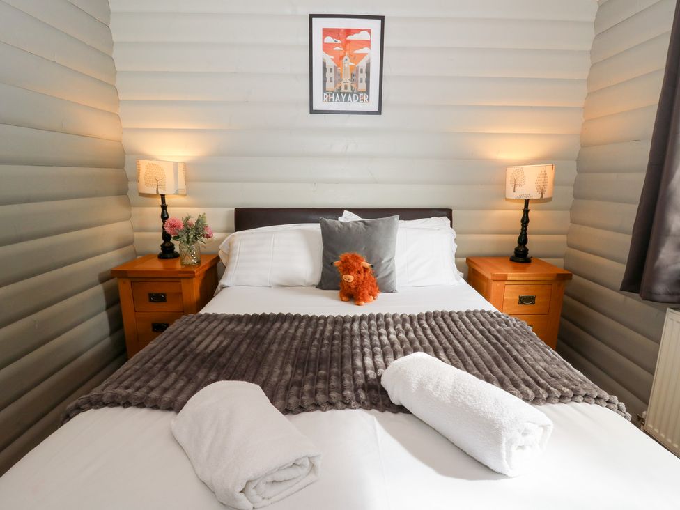 A bedroom with a bed and side tables at Sunny View in Rhayader